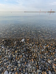 Small waves running ashore from small stones on the black sea in the city of sochi