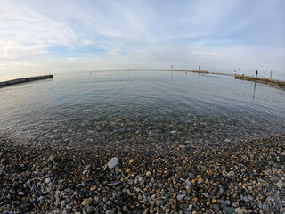 Small waves running ashore from small stones on the black sea in the city of sochi