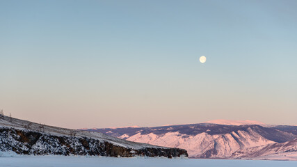 Fototapeta premium Moon in the morning above Baikal lake in winter