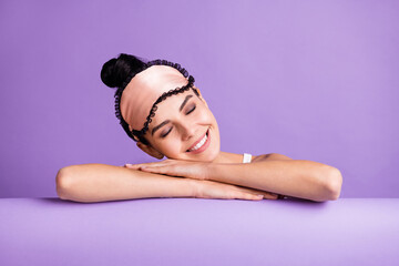 Obraz na płótnie Canvas Photo portrait of cute girl wearing sleeping mask top knot smiling sleeping dreaming isolated on pastel purple color background