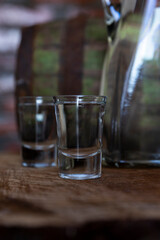 Hard alcoholic drink or brandy from fermented fruits, old wooden table, still life