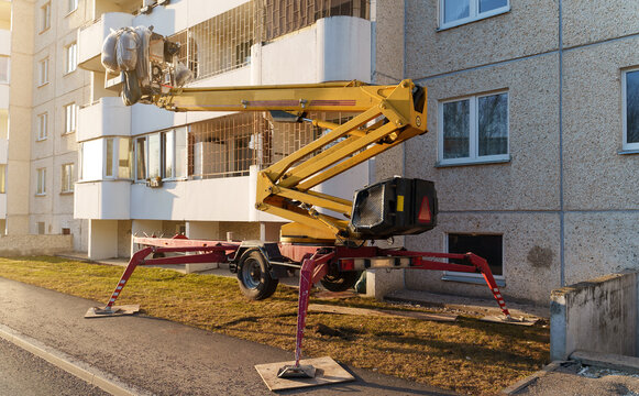 Articulated telescopic boom lift on wheels is ready for facade works.