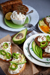 Sandwiches with soft cheese, avocado and cucumber. Breakfast is on the table. Healthy food. Toast and spread on it. Avocado sandwich stilllife. Healthy food. Toast.