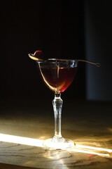 Delicious and fresh cocktail stands on the bar counter with cherries