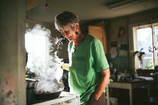 Smiling woman preparing food in kitchen