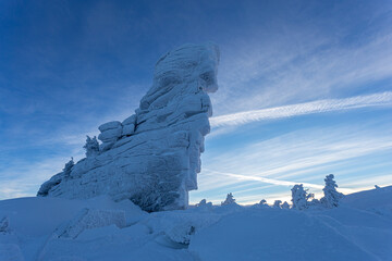 unrealistically beautiful and magical rock shrouded in snow frost. a large stone for conducting...