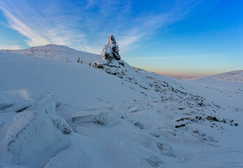 unrealistically beautiful and magical rock shrouded in snow frost. a large stone for conducting...
