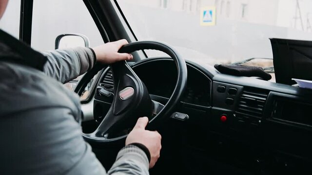 Hands Of The Truck Driver On The Steering Wheel, The Road Is Bumpy, Shaking.