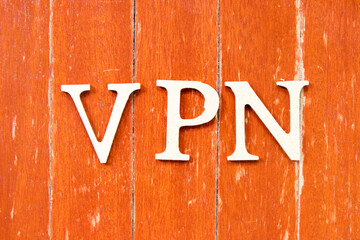 Alphabet letter in word  VPN (abbreviation of virtual private network) on old red color wood plate background