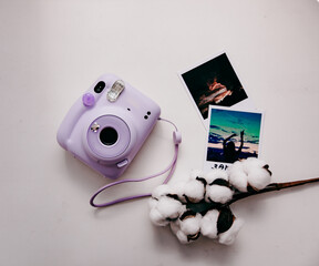purple polaroid on white background and accessories