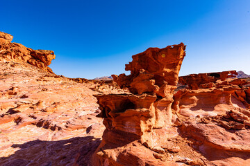 Fototapeta na wymiar Little Finland, Nevada. Also know as Devil's Fire or Hobgoblin Playground. A collection of amazing, bizarre and complex reddish and orange rock formations that were formed out of Navajo sandstone.