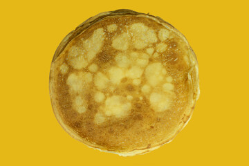 Pancakes on a yellow isolated background, top view
