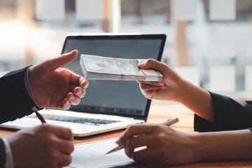 Man offering batch of hundred dollar bills. Venality, bribe, corruption concept. Hand giving money - United States Dollars (or USD). Hand receiving money from businessman.