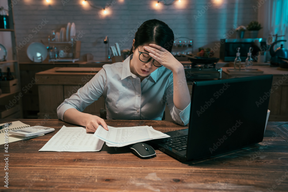 Wall mural tired asian chinese businesswoman working on laptop computer until night. portrait of casual stresse