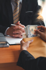 Man offering batch of hundred dollar bills. Venality, bribe, corruption concept. Hand giving money...