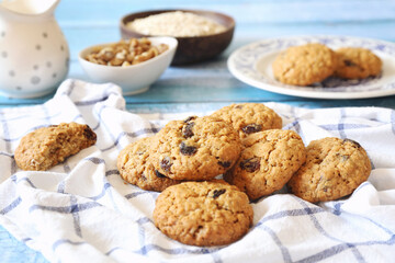 Homemade oatmeal cookies with raisins and walnuts - obrazy, fototapety, plakaty