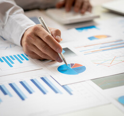 Financial Business man analyze the graph of the company's performance to create profits and growth,...