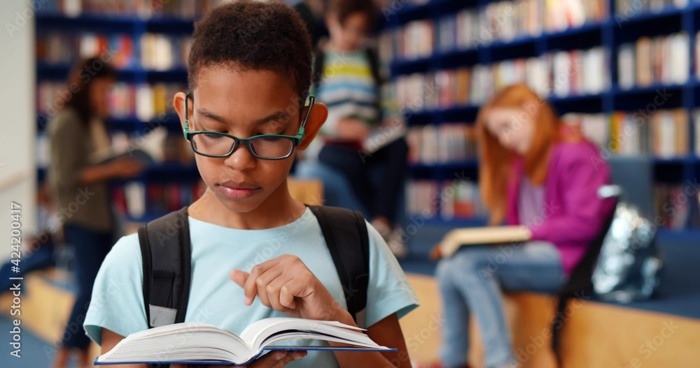 Poster smart african-american student boy reading book in library