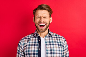 Photo of young excited handsome man happy positive smile humor joke laugh isolated over red color background