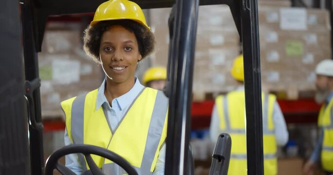 African female forklift operator working in a warehouse