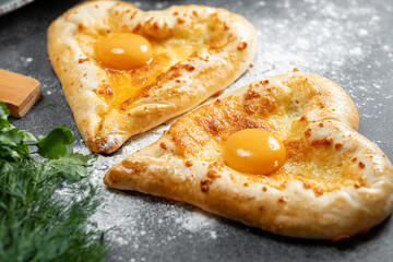 two khachapuri in the shape of a heart. dinner in a Georgian restaurant for two on Valentine's Day