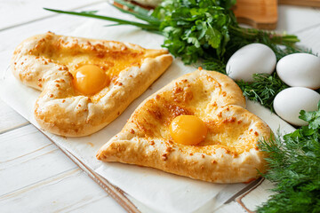 two khachapuri in the shape of a heart. dinner in a Georgian restaurant for two on Valentine's Day