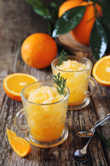 Orange granita, frozen summer dessert and  freshe orange fruits