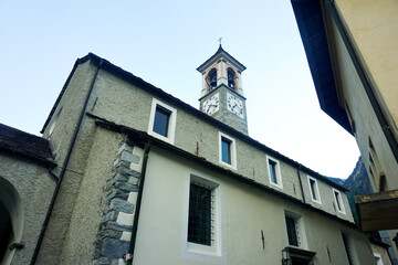 Fototapeta na wymiar Church and bell tower of Santi Luca e Abbondio, Avegno, Switzerland