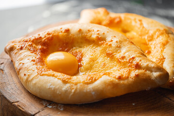 two Adjarian khachapuri in traditional classic Georgian style.