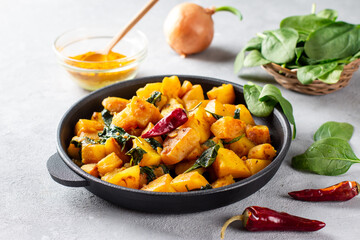 Aloo Palak sabzi or Spinach Potatoes curry served in a frying pan. Popular Indian healthy recipe