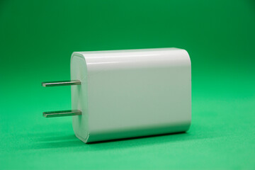 Separate phone charger on green background