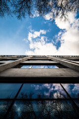 Facade of city stadium reflecting sky on sunny day