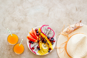 Plate of exotic tropical fruits, top view. Vacation and diet concept