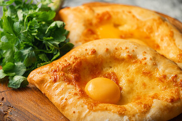 two Adjarian khachapuri in traditional classic Georgian style.