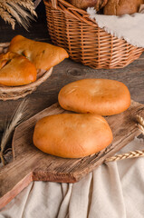 Appetizing fresh culinary pastry - pies with different fillings on a wooden