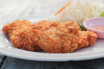Shrimp donut cake in wood dish with sweet sauce, Thai food made from minced shrimps mixed with seasoning and then fried to a crisp and mellow taste, Delicious children's menu with prawn meat protein.
