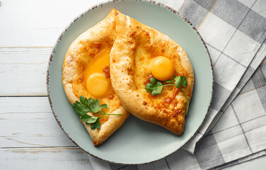 two Adjarian khachapuri in traditional classic Georgian style.