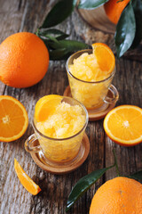 Orange granita, frozen summer dessert and  freshe orange fruits
