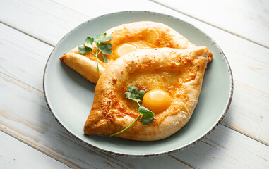 two Adjarian khachapuri in traditional classic Georgian style.