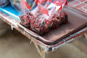 Fresh mulberry in plastic bags sold in rural areas in Thailand looks delicious. Healthy fruit And...