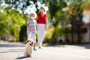 Obraz premium Family walking dog during virus outbreak
