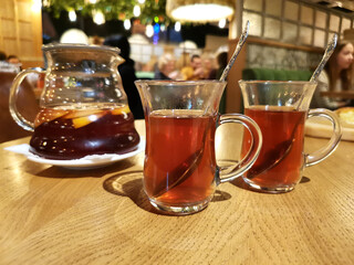on the table in the Georgian restaurant stands tea in glass mugs and a kettle