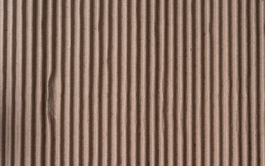 Corrugated brown cardboard sheet of paper texture or background, folded carton paper