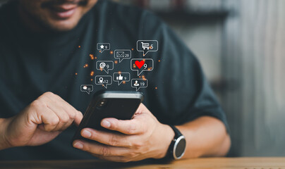 Man using smart phone with notification icons of love, like, message, comment, email, address, shopping and star above smartphone screen, Social, media, Marketing concept.