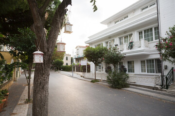 An empty street with white houses and decorative lanterns in an old part of Istanbul, Prince island. Popular travel destination, no tourist at a pandemic time.