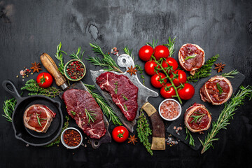 Variety of raw black angus prime meat steaks beef rump steak, Tenderloin fillet mignon for grilling on old meat cleaver on dark background. banner, menu recipe top view