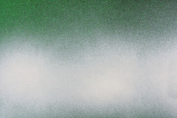 Obraz premium white and red spray paint on a green colored paper background