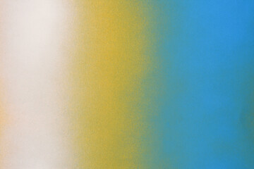 white and blue spray paint on a yellow colored paper background