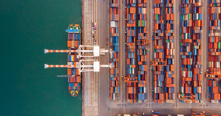 Smart crane loanding cargo container to container ship in the international terminal depot sea yard...
