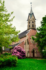 Small Gothic Christian Catholic chapel in a green garden